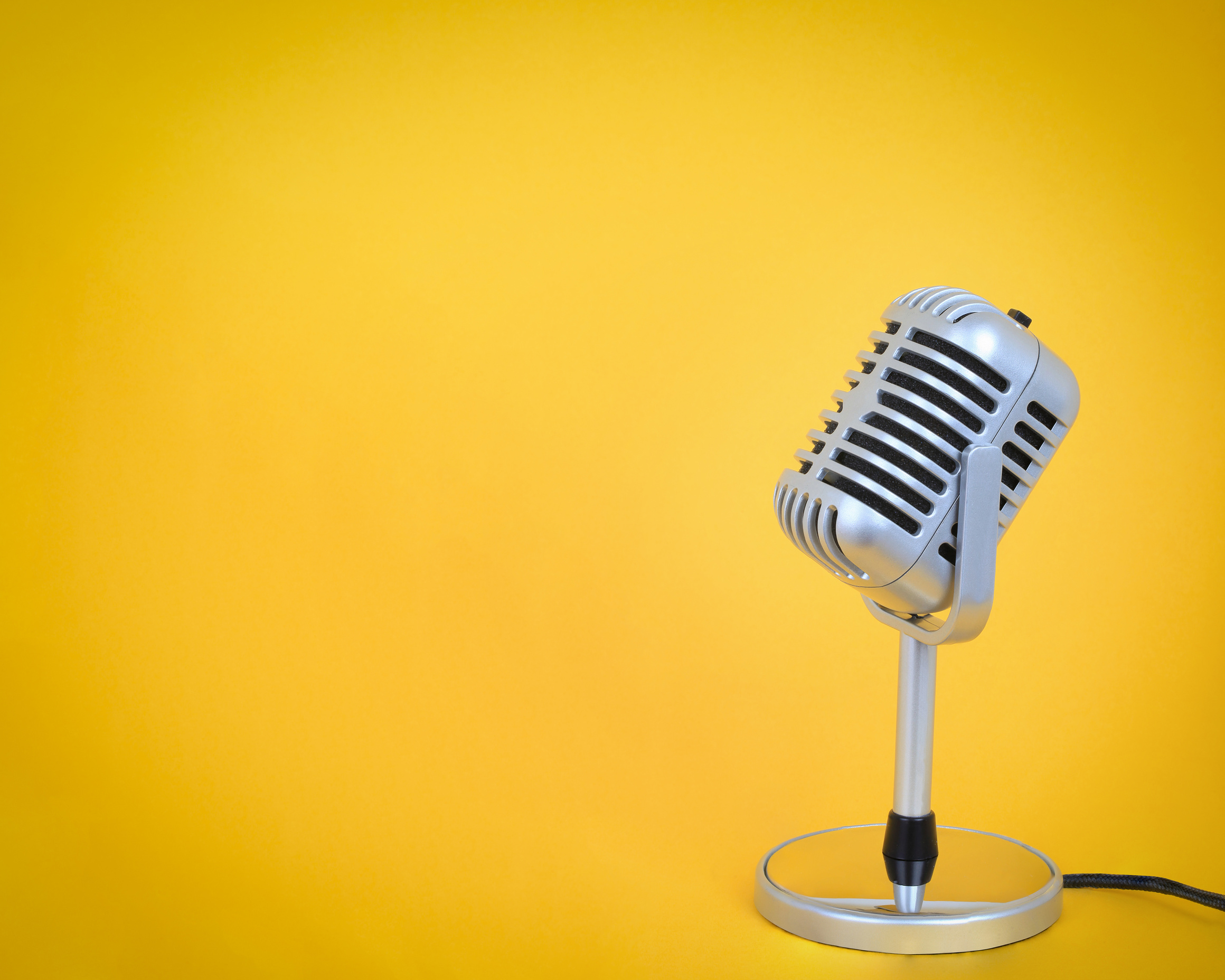 Retro microphone Vintage silver  with yellow background.
